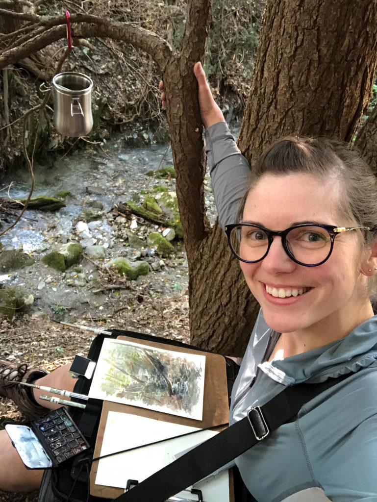 Jill posing with the Etchr Slate setup after painting next to a creek.