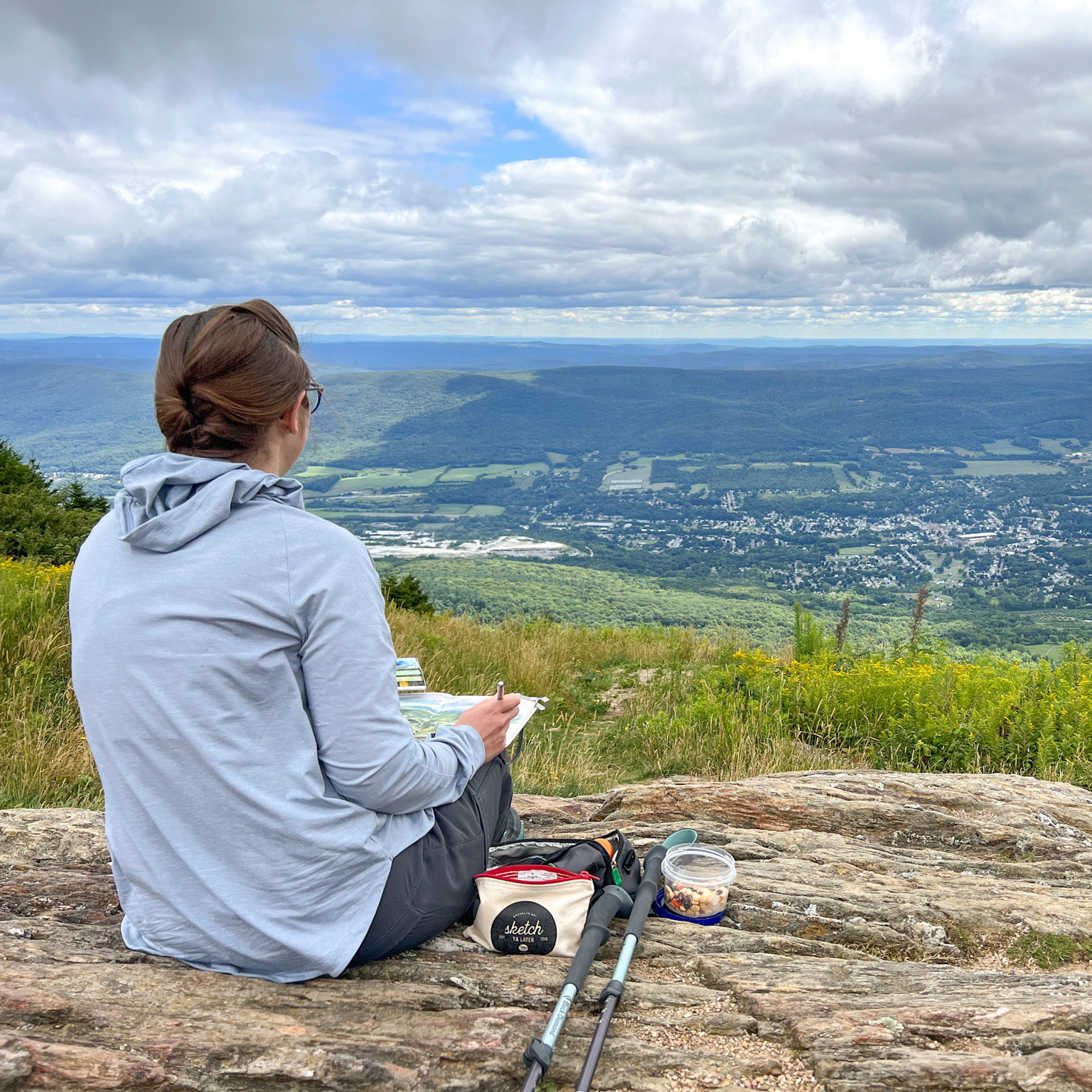 Jill at the summit of Mount Greylock observing the vista and going a landscape painting sketch.